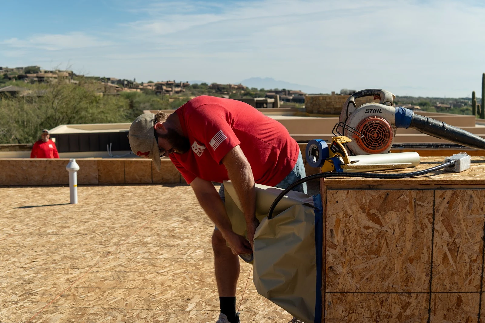 Crew member working on a flat roof deck